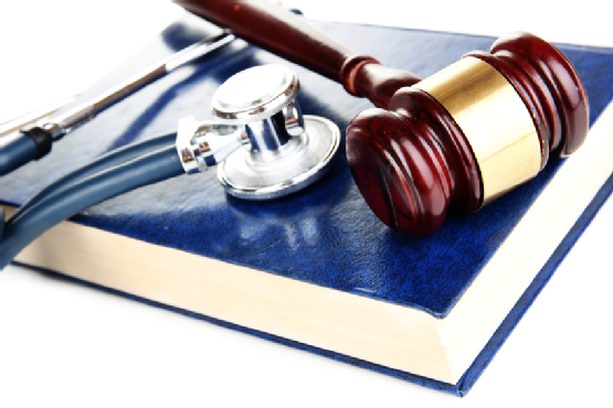 Medicine law concept. Gavel and stethoscope on book close up