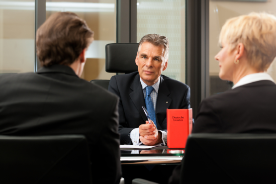 Lawyer or notary with clients in his office