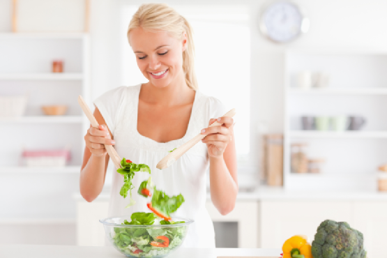 Gorgeous woman mixing a salad