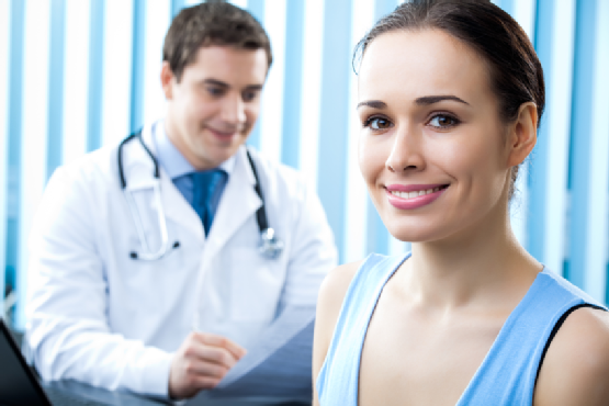 Happy female patient and doctor at office