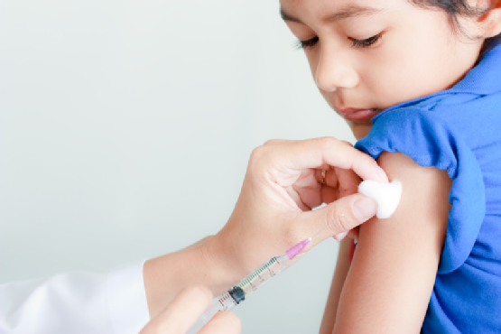 Boy and vaccine syringe