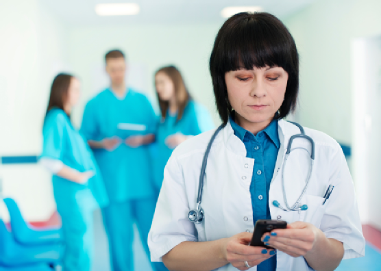 Portrait of female doctor with interns in background