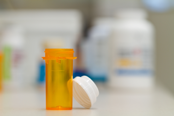 empty pharmacy vial and cap